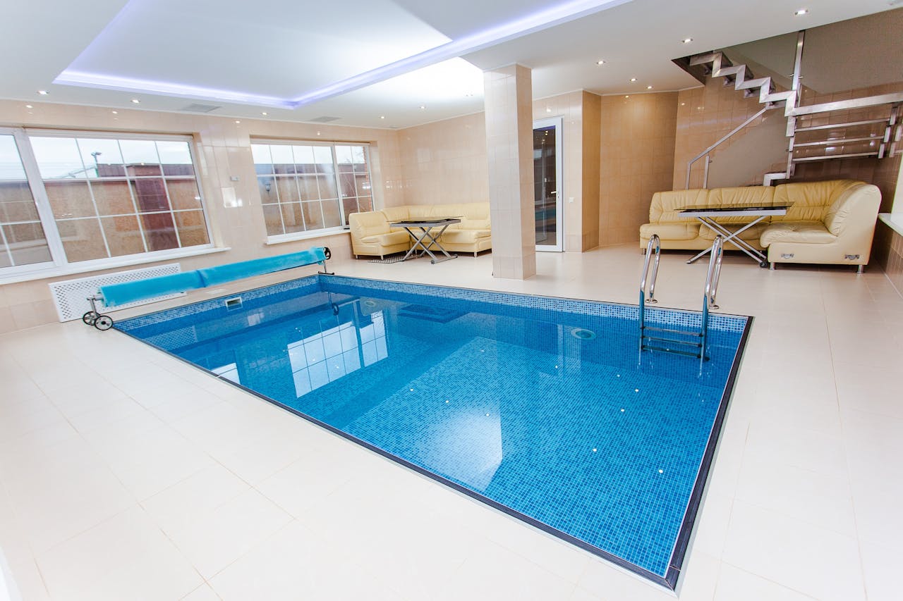 our-story Luxurious indoor pool area featuring modern design and elegant furnishings.