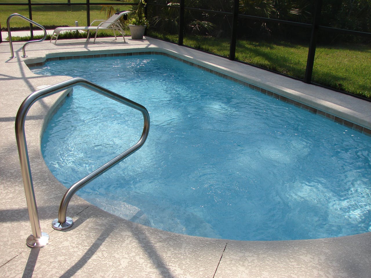 services-03 A tranquil image of a clean swimming pool set in a sunny backyard, perfect for relaxation.